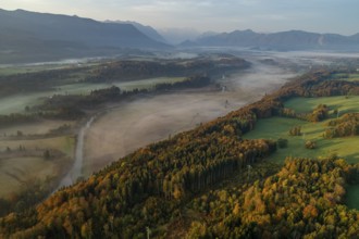 Aerial view of a mountain landscape with river, morning light, mountains, fog, autumn, view of