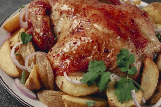 Fried, baked chicken, in the oven, with spices, and rustic potatoes, top view, homemade