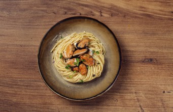 Spaghetti with mussels, without shell, pasta with peeled mussels, in carbonara sauce, micro-greens,