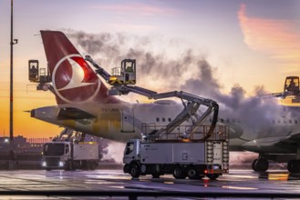 Frost at the airport, a Turkish Airlines aircraft is de-iced in front of sunrise. Airbus A321-231,