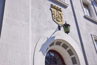 Facade of a house in the classicist style with the coat of arms of the salt boiling trade and