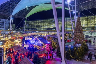 Christmas market at the airport in the evening, market stalls decorated for Christmas in front of