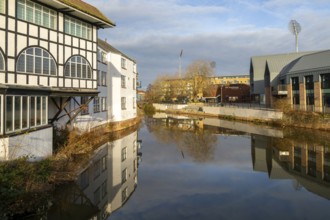 Reflection of buildings in water of River Tone, Dellers Wharf, Taunton, Somerset, England, UK