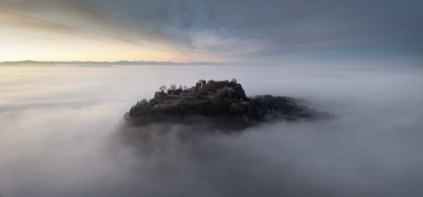 Aerial panorama of the Hegau volcano Hohentwiel with the upper fortress ruins in front of sunrise,