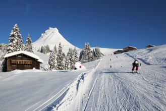 Snow-covered mountains and mountain hut with ski slope, Damülser Mittagspitze, Damüls,