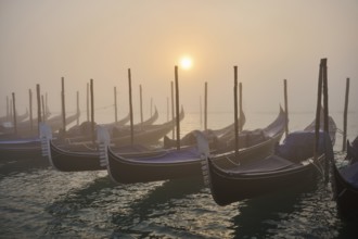 View from 'Colonna di San Marco e San Teodoro' on the gondolas lying in the water at sunrise in
