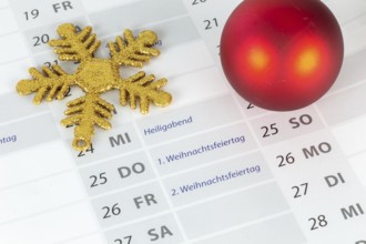 Close-up of a section of a calendar showing the 2025 Christmas holidays with Christmas decorations