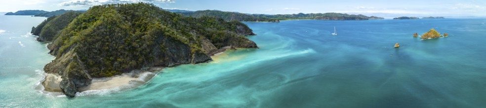 Aerial view, tropical islands and sailing boat in the turquoise ocean, Tortuga Island, Puntarenas,