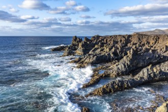 Rocky coast with crashing waves and blue sky, Canary Islands, Lanzarote, Spain, Europe