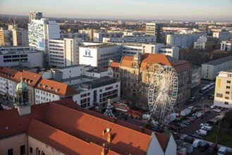 High-rise buildings in the city centre with Ferris wheel at the Christmas market, Magdeburg,
