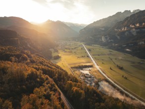 View of a wide valley at dusk with roads, fields and mountains, Meiringen, Switzerland, Europe