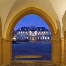 View from the open hall of the late Gothic town hall in Goslar in the evening onto the market