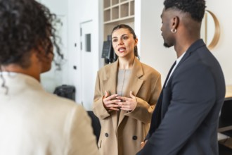 Businesswoman gesturing while speaking to her colleagues during a team meeting in a modern office
