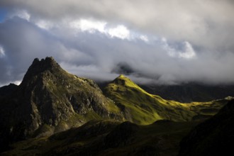 Grassy mountains with light mood and threatening clouds, Tschagguns, Rätikon, Montafon, Vorarlberg,