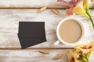Black paper business card mockup with orange day-lily flower and cup of coffee on white wooden