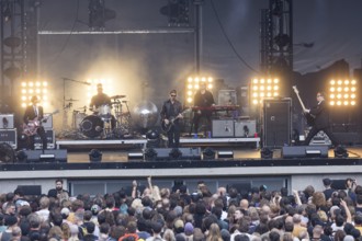 Daniel Kessler (guitarist), Samuel Sam Fogarino (drummer), Paul Banks (singer), Brandon Curtis