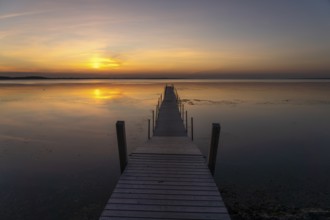 Sunset on a jetty in the Limfjord near Hvalpsund, Denmark, Europe
