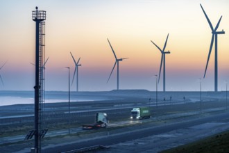 Lorry on the road to Euromax Terminal Rotterdam, ENECO wind farm on the dike around the port of