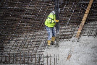 Construction site, concreting, the foundation of a building is concreted, the concrete is pumped