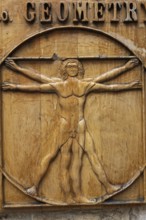Close-up of Vitruvian man drawing by Leonardo da Vinci carved on a wooden plaque, Old Town of