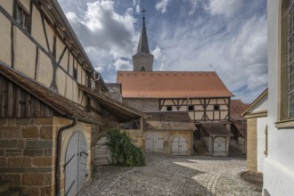 Former so-called Kirchgaden, barns in the historic fortified church, behind the tower of the church