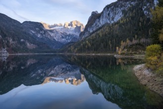 The Vordere Gosausee lake in autumn with a view of the Dachstein mountain range. The Gosaukamm on