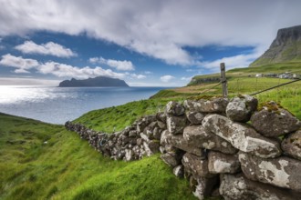 View of the island of Mykines, old stone wall, Gásadalur village, Vágar, Faroe Islands, Denmark,