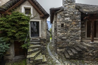 Typical Ticino stone houses in a narrow alley in the mountain village of Bordei, Centovalli, Canton