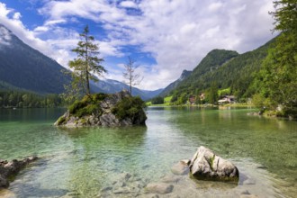 Hintersee near Ramsau with clear green water, surrounded by forests and mountains under a cloudy