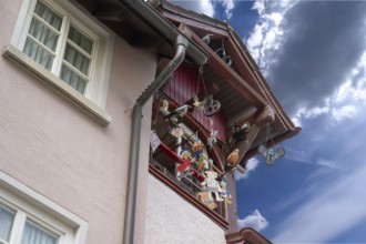 Historic roof lift bay window decorated with colourful figures, Villingen-Schwenningen,