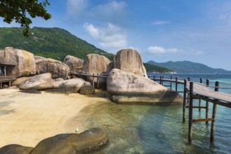 Wooden jetty with granite rocks at the entrance area of Nang Yuan Island, island, holiday island,