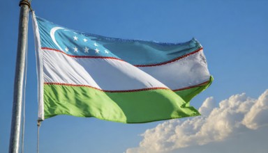 Flags, the national flag of Uzbekistan flutters in the wind