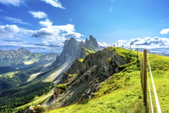 Majestic peaks of seceda rise above lush green valleys and meadows in the italian dolomites, a