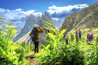 Female hiker enjoying the breathtaking view of the odle mountains on seceda during a sunny summer