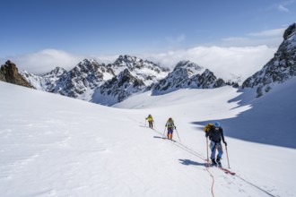 Ski tourer with rope, rope team on the Vadret da Porchabella glacier on the ascent to the summit of