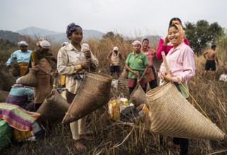 Villagers participate in a community fishing event on the occasion of the Bhogali Bihu festival at