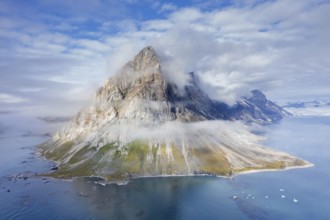 Gnalberget, mountain with steep sea cliffs in Hornsund fjord at Gnålodden in summer, Svalbard,