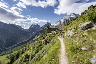 Hiking trail through picturesque mountain landscape near Arolla, behind mountain peak Mont Collon,