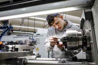 Remscheid, North Rhine-Westphalia, Germany - Trainees in metal professions, here at a machine tool,