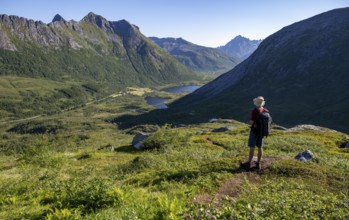 Mountaineers on a hiking trail to the summit of Rundfjellet, mountain landscape and valley with