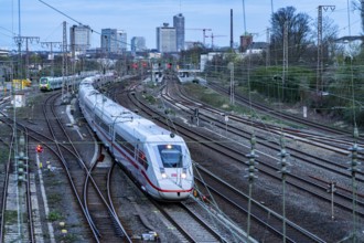 Train on the tracks west of Essen central station, skyline of the city centre, ICE train, North