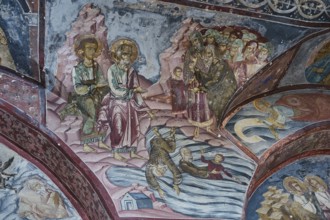 Historical fresco with a biblical scene of people in the water, surrounded by other biblical