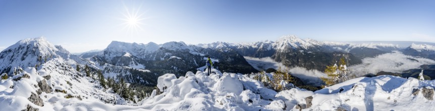 Panorama, mountaineer on the snowy summit of the Jenner in autumn, view of the sea of clouds and