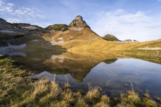 Lake Augstsee and the Atterkogel mountain on the Loser. Autumn, good weather, blue sky. Reflection.