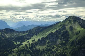 Views of green mountain slopes, forests and a cloudy sky make for impressive natural scenery in the