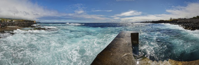 Former whale towing facility in stormy sea with waves and clouds in the sky, whale station and