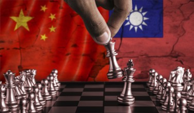 China vs Taiwan flag concept on chessboard. Political tension between China and Taiwan on pieces of