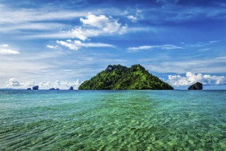 Vacation holidays concept background, tropical island and long-tail boat in sea. Thailand