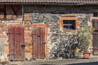 Historic farmhouse around 1800, half-timbered façade, sandstone, natural stone, brick, weathered