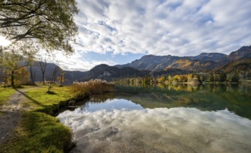 On the shore of Lake Lake Kochel with reflection, autumn landscape with mountain peaks Herzogstand